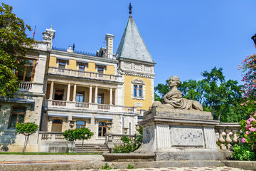 Fototapeta na wymiar Panorama of Massandra palace in baroque style with its park and statue of sphinx with female head. Building founded in 1881. Shot in Massandra, near Yalta, Crimea