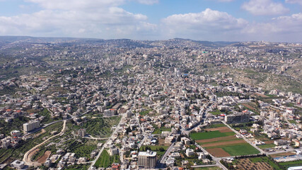 Aerial view over Bethlehem City, Palestinian Authority
Drone view over buildings and fields in the morning, March 2021
