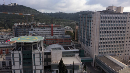 Fototapeta premium Hadassah ein kerem Hospital in Jerusalem mountains, aerial view Medicine buildings hospital and traffic, Jerusalem, israel 