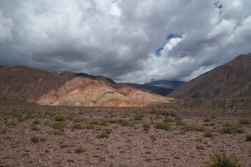 Volcanic landscape in the cordillera. View of the arid desert and colorful mountains under a beautiful sky.