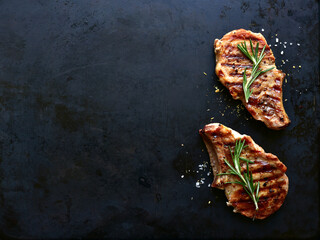 Grilled pork loin on a bone. Top view with copy space.
