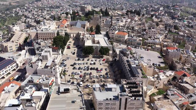 Aerial view over Church of the Nativity And City Square Of Bethlehem
, Morning shot from Bethlehem, the town where Jesus was born. Place of The Church of the Nativity
