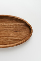 Half wooden plate on white background. Wooden utensils on white background. Dishes made of natural materials.