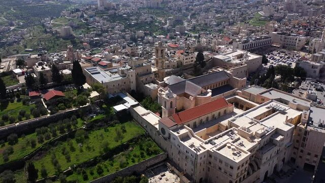 Aerial view over Church of the Nativity And City Square Of Bethlehem
, Morning shot from Bethlehem, the town where Jesus was born. Place of The Church of the Nativity
