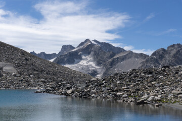 An alpine lake in the Swiss Engadine Mountains, near the village of Sankt Moritz, Switzerland - August 2020.