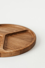 Half Compartmental dish on white background. Cookware made of natural materials. Wooden bowl.