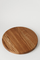 Wooden tray with a round shape. Beautiful ash wood texture. Dishes made of natural materials.
