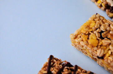 One bar of muesli close-up on a blue background with a copy space. High quality photo