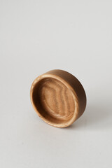 Round natural wood product on a white background. Round ash wood bowl.