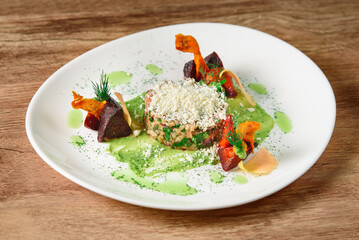 Porridge with vegetables and pesto sauce sprinkled with cheese. Beautiful, tasty, healthy restaurant food