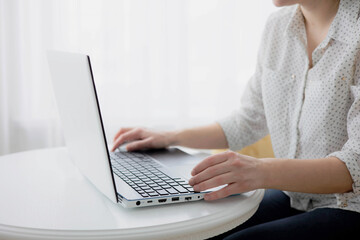 Woman hands on keypad laptop. Woman working at home office