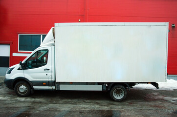 Several cars vans trucks parked in parking lot for rent or delivery