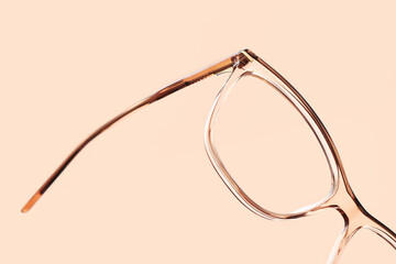 eyewear spectacles close up isolated on beige background - obrazy, fototapety, plakaty
