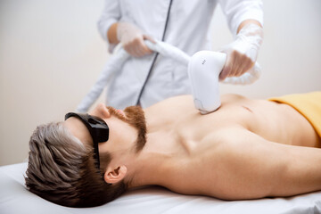 Man torso chest under treatment in hair removal laser epilation studio