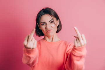 Woman wearing casual sweater on background showing middle finger doing bad expression, provocation and rude attitude