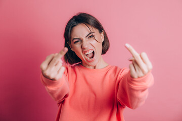 Woman wearing casual sweater on background showing middle finger doing bad expression, provocation...