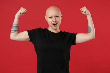 Young bald caucasian tattooed attractive fitness secret strong sporty woman 20s without hair in...