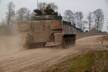 Fototapeta premium British army FV510 warrior light infantry fighting vehicle armoured tank in action on a military exercise, Wiltshire UK