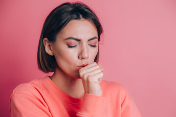 Fototapeta premium Woman wearing casual sweater on background feeling unwell and coughing as symptom for cold or bronchitis. Healthcare concept.
