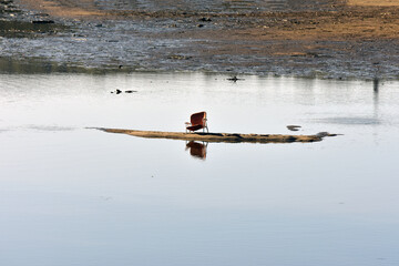 Abandoned chair on a lake