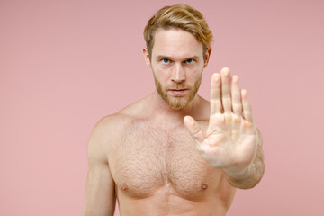 Concerned serious bearded naked young man 20s years old perfect skin showing stop gesture with palm...