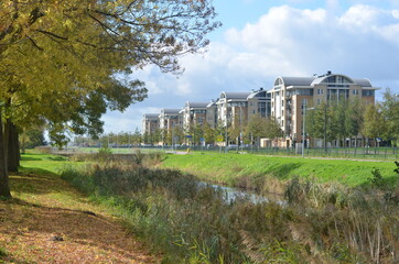 Fototapeta na wymiar Apartment house complex consisting of five buildings in Hoofddorp surrounded by trees