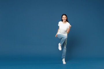Full length young happy excited overjoyed latin woman 20s in white casual basic t-shirt do winner...