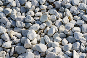 The texture of natural sea pebbles, white rounded stones.