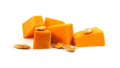Pieces of pumpkin isolated on white background. Pumpkin seed. Pumpkin pieces cut in a cube slice isolated on white background. 