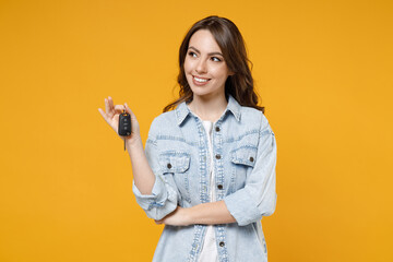 Young smiling dreamful pensive wistful happy rich brunette woman 20s wearing stylish denim shirt...
