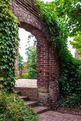 Afferden, Limburg, Netherlands - May 20, 2020: Old overgrown entrance gate as entrance to the local cemetery