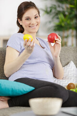 woman in pregnant holding fresh apples