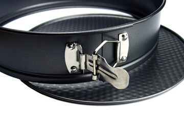 Disassembled round metal baking dish with non-stick coating isolated on white