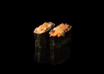 Spicy Gunkan maki sushi with unagi, black background