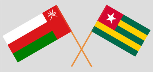 Crossed flags of Oman and Togo. Official colors. Correct proportion