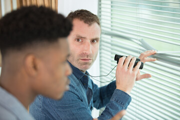 man and brefin looking out the window