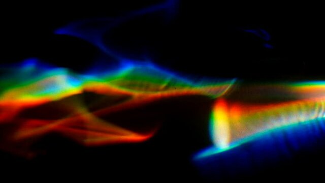 Rainbow colored caustics making beautiful geometrical waves of color over a flat surface