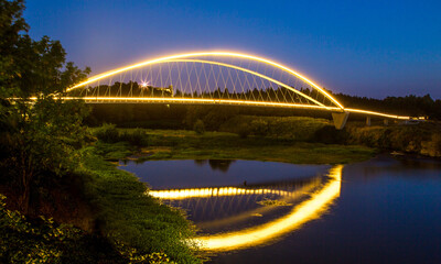 Fototapeta na wymiar Double arch footbridge at sunset from Salem Riverfront park to Minto Island, Oregon.