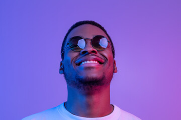 Closeup Shot Of Dreamy African American Man In Stylish Sunglasses, Neon Lighting