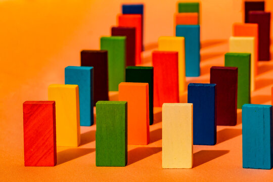 Close-up of toy blocks arranged in a line on orange background