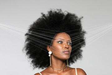 Afro woman with facial recognition laser beam while looking away against white background