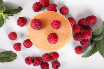 Tasty american pancakes with raspberries, blueberries and honey. Top view