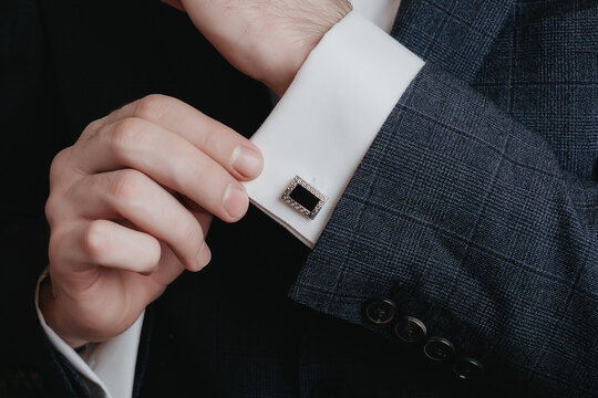 Close up of businessman wearing cufflinks. Elegant young fashion business man wearing suit. - Powered by Adobe