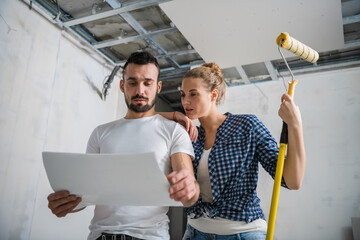 The young girl hugs man. They consider the layout of the house
