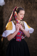 Young beautiful slovak woman in traditional dress. Slovak folklore