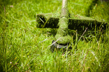mowing a green lawn with a lawn mower