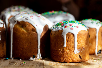 Many Traditional eastern europe Russian and ukrainian Easter cake kulich decorated with sweet sugar icing on wooden table morning sunlight ray. Tasty handmade christian orthodox holiday paska bread
