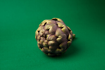 Obraz premium Fresh Artichoke on the dark green background