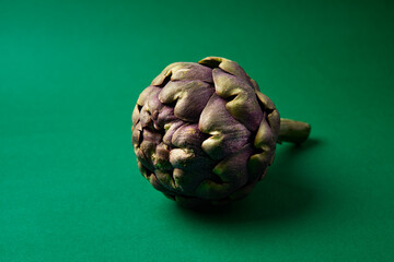 Obraz premium Fresh Artichoke on the dark green background