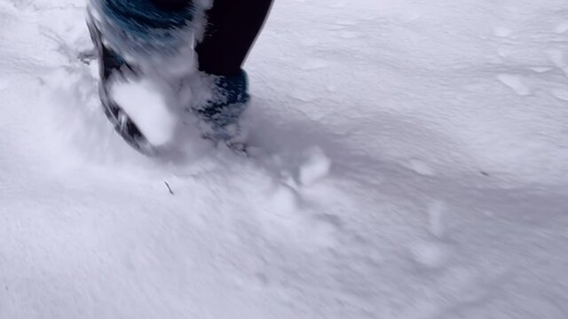 Walking in the snow. Camera following footsteps of female walking in boots in the forest. Different angles. High quality audio of crunching snow and woodland ambience. ASMR style video.